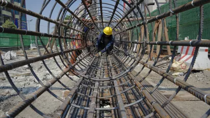 Construction of a cylindrical metal structure. City of Yangon (Rangoon), Myanmar, 2013.