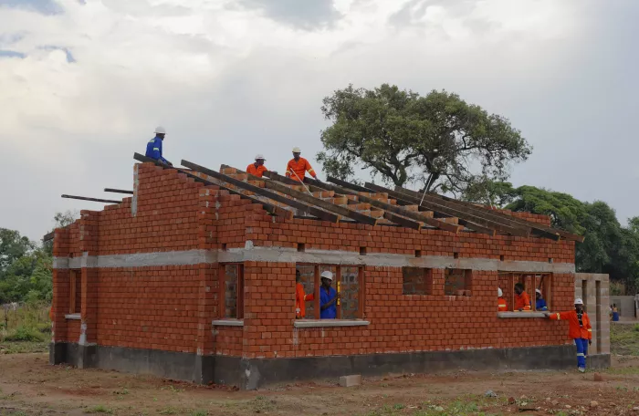 consutrction workers building a house in Africa