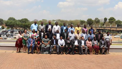 Participants to a meeting pose for a group photo