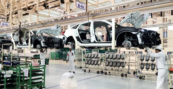 Workers in Thailand at an auto parts manufacturing plant
